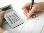 Bookkeeping With Calculator Stock Photo