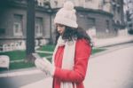 Beautiful Woman In Red Coat And Wool Cap And Gloves With Smartph Stock Photo