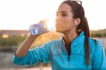 Portrait Of Young Woman Drinking Water After Running Stock Photo