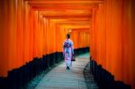 Asian Women In Traditional Japanese Kimonos At Fushimi Inari Shrine In Kyoto, Japan Stock Photo