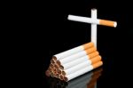 Cigarettes And Cross Stock Photo