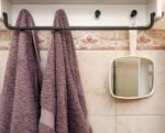 Hanging Objects In The Bathroom: Two Towels And A White Mirror Stock Photo