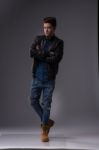 Casual Young Man In Black Leather Jacket And Denim Jeans Stock Photo