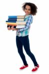 Active Young School Kid Carrying Books Stock Photo