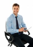 Seated Young Male Using Tablet Pc Stock Photo