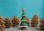 Christmas Ornament With Christmas Tree And Pine Cone In Snow Stock Photo