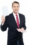 Executive Showing Blank Playing Card To Camera Stock Photo