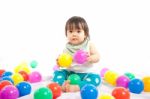 Baby Girl Is Playing Ball On White Background Stock Photo