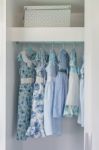 Blue Color Tone Girl's Dress Hanging In Wardrobe Stock Photo