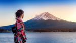 Asian Woman Wearing Japanese Traditional Kimono At Fuji Mountain. Sunset At Kawaguchiko Lake In Japan Stock Photo