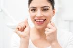 Woman Cleaning Her Teeth By Dental Floss Stock Photo