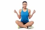 Woman Meditating In Pose Of Lotus Stock Photo