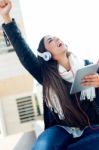 Beautiful Girl Listening To Music In City Stock Photo