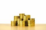 Plenty Of Gold Coins On Wood Table Isolated On White Background Stock Photo