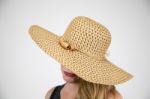 Female In Large Hat Hiding Face Stock Photo