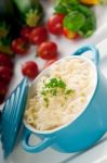 Mac And Cheese On A Blue Little Clay Pot Stock Photo