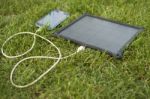 Mobile Phone Charging With Solar Energy - Charger Stock Photo