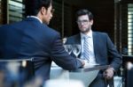 Two Smiling Business Men Have Dinner At Restaurant Stock Photo