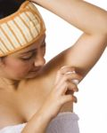 Girl Putting Underarm Deodorant Stock Photo