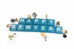 Miniature Worker Team Building Word Happy New Year On White Background Stock Photo