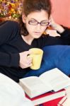 Woman Reading Book At Home Stock Photo