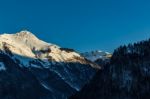 Snowy Mountain Tops In The Blue Sky Sun Stock Photo