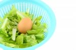 Egg On Vegetable Basket On White Background Stock Photo