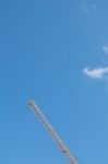 Yellow High Long Crane Arrow At Construction Site With Clear Light Blue Sky Day Stock Photo