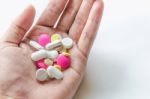 Top View Of The Pills On The Hand And White Background, A Hand Hold The Pills And Drug Stock Photo