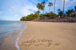 Inscription Of Vacation Written On Wet Yellow Beach Sand With Fo Stock Photo