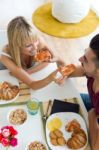 Happy Young Couple Enjoying Breakfast In The Kitchen Stock Photo