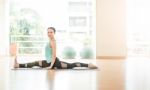 Asian Woman Doing Yoga Indoors Stock Photo