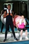 Man And Woman Exercising In Gym Stock Photo