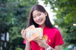 Portrait Of Thai Teen Beautiful Girl In Chinese Dress, Happy New Year And Open Box Gift, Smile And Very Happy Stock Photo