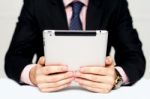 Businessman's Hands Holding Portable Device Stock Photo