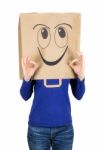 Happy Smiling Woman With Paper Bag On Head Stock Photo