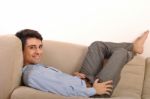 Man Relaxing On The Couch Stock Photo