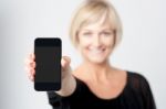 Woman Displaying New Phone In Market Stock Photo