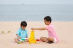 Young Brothers Play On Beach Stock Photo