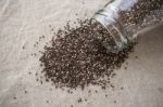 Chia Seeds Spilled Out Of Bottle Stock Photo