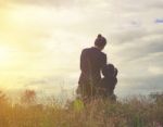 Mother And Daughter On Sunset Watching On Sky Stock Photo