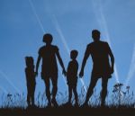 Young Family In Park Stock Photo