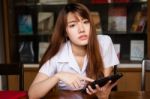 Portrait Of Thai Adult Student University Uniform Beautiful Girl Using Her Tablet Stock Photo