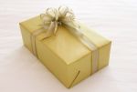 Gift Box With Ribbon Bow On Bed Stock Photo