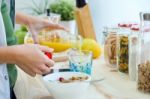 Pretty Young Woman Enjoying Breakfast In The Kitchen Stock Photo