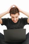 Shocked Young Man With Laptop Stock Photo