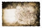 An Old Bicycle In The Garden On The Old Brown Burnt Paper Stock Photo