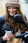 Young Woman Over A Motorcycle On The Street With His Mobile Phon Stock Photo