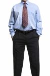 Businessman In Blue Shirt Standing With Hands In Pockets Stock Photo