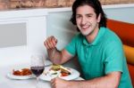 Handsome Guy Enjoying His Meal Stock Photo